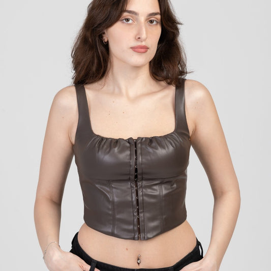 model in Vegan leather corset top in front of white background