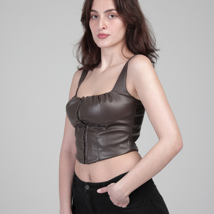 model in Vegan leather corset hand in pocket, standing on side