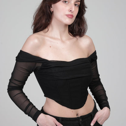 model in black corset top with sleeves, front photo slide righr position. model is in front of white background 